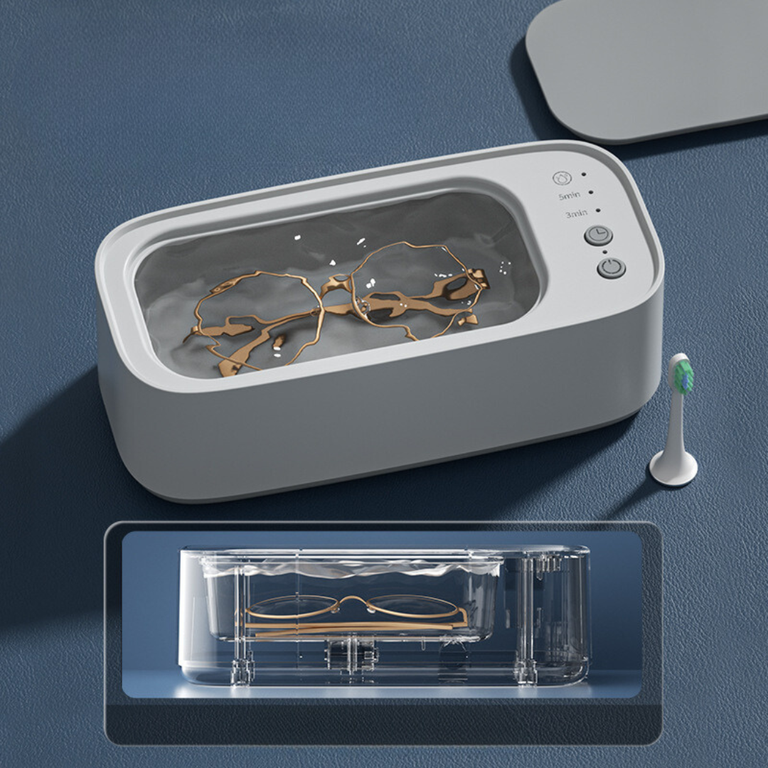 Kompakt ultralydsrenser i blå-gul til effektiv rengøring af smykker, ure og briller.